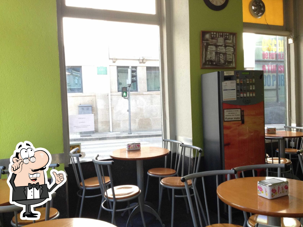 Cafe David's interior with seating, tables, and a bright street view